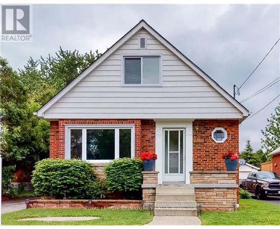 A house with a grey roof and a white door is for sale.