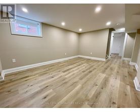 A room with wooden flooring and a window.