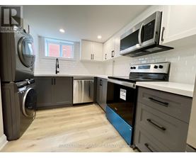 A kitchen with a stainless steel refrigerator, oven, and microwave.