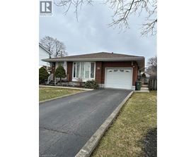 A house with a white garage door is for sale.
