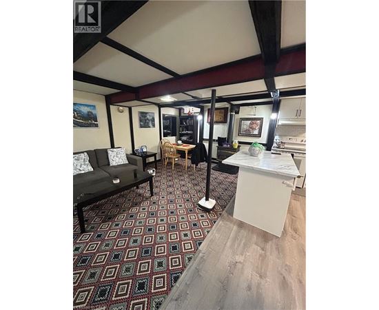 A room with a patterned carpet and a white table.