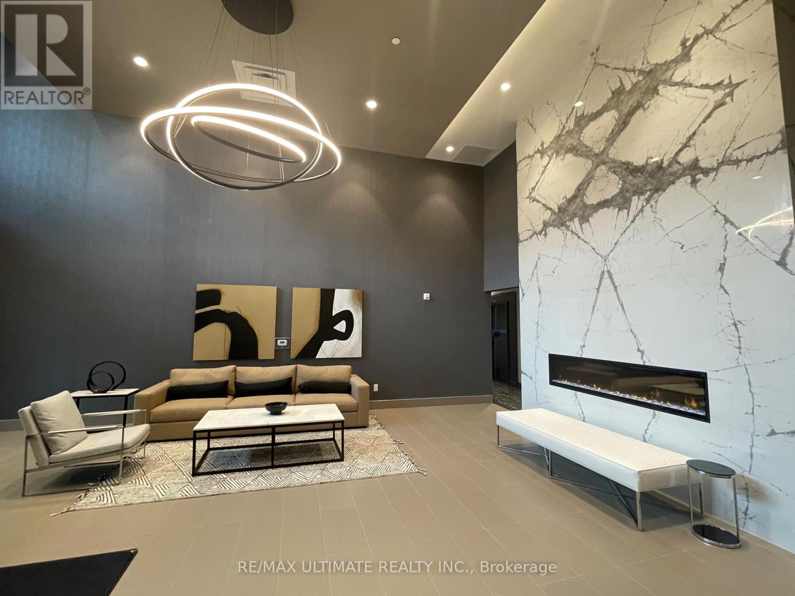 A modern living room with a fireplace and a large painting on the wall.