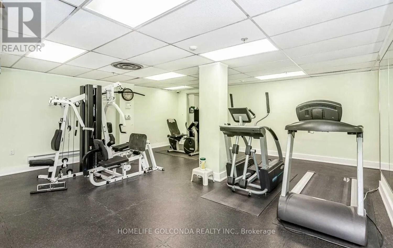 A well-equipped gym with a treadmill, weights, and other exercise machines.