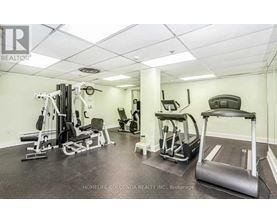 A well-equipped gym with a treadmill, weights, and other exercise machines.