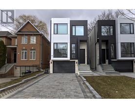A modern house with a brick house in the background.