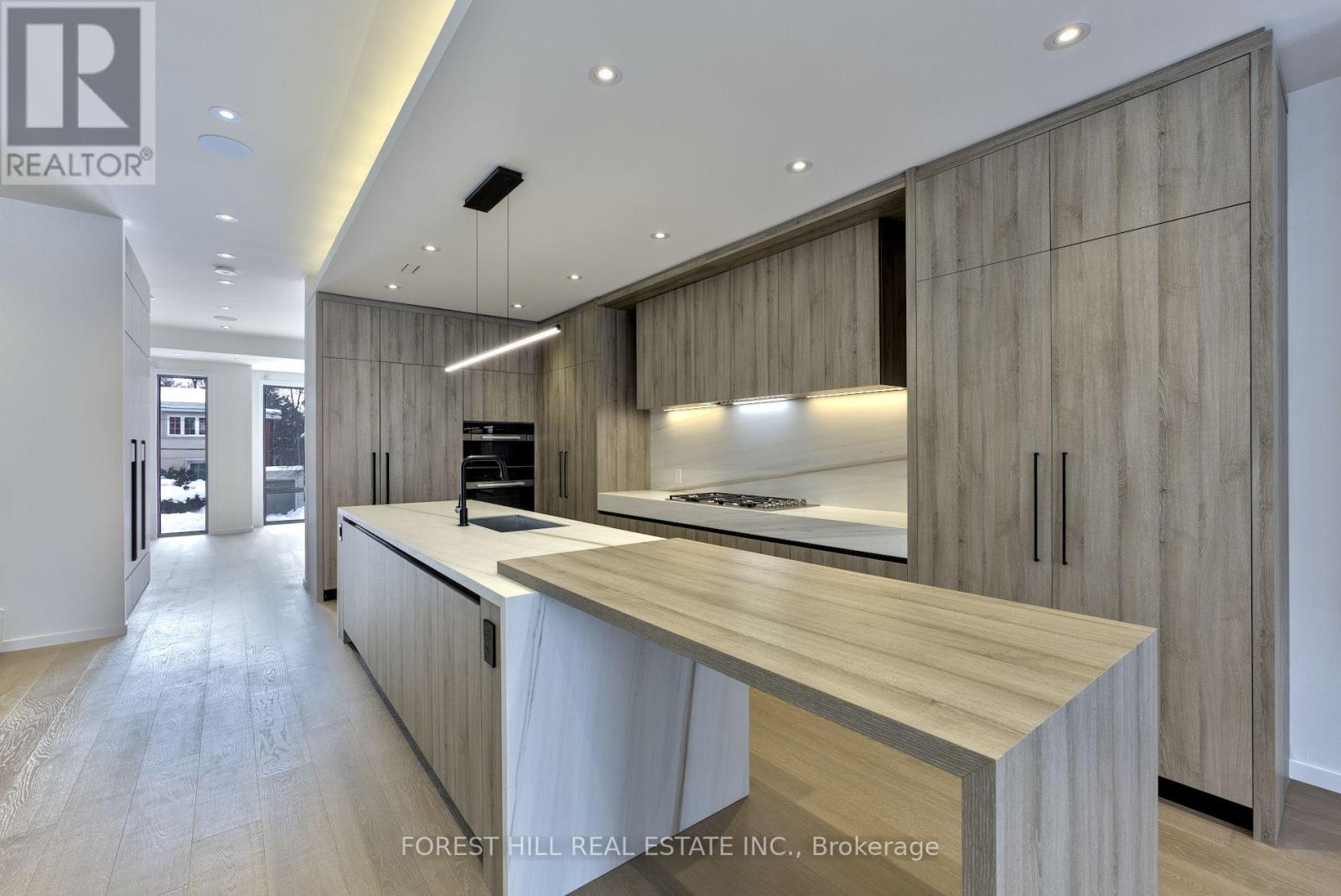A modern kitchen with wooden cabinets and a central island.