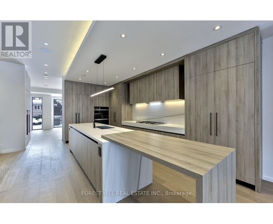 A modern kitchen with wooden cabinets and a central island.