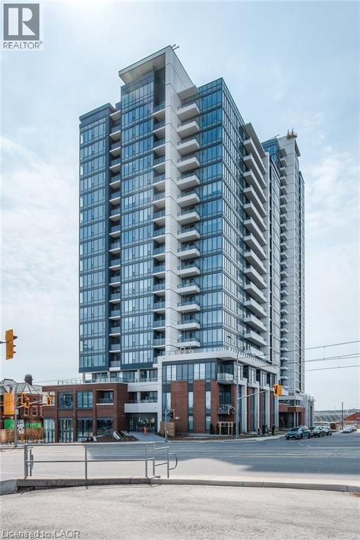 A modern multi-story building with a glass facade is under construction.