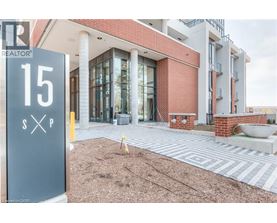 A realtor sign is in front of a building.