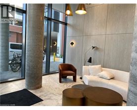 A modern living room with a sofa, armchair, and coffee table.
