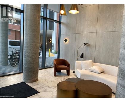 A modern living room with a sofa, armchair, and coffee table.