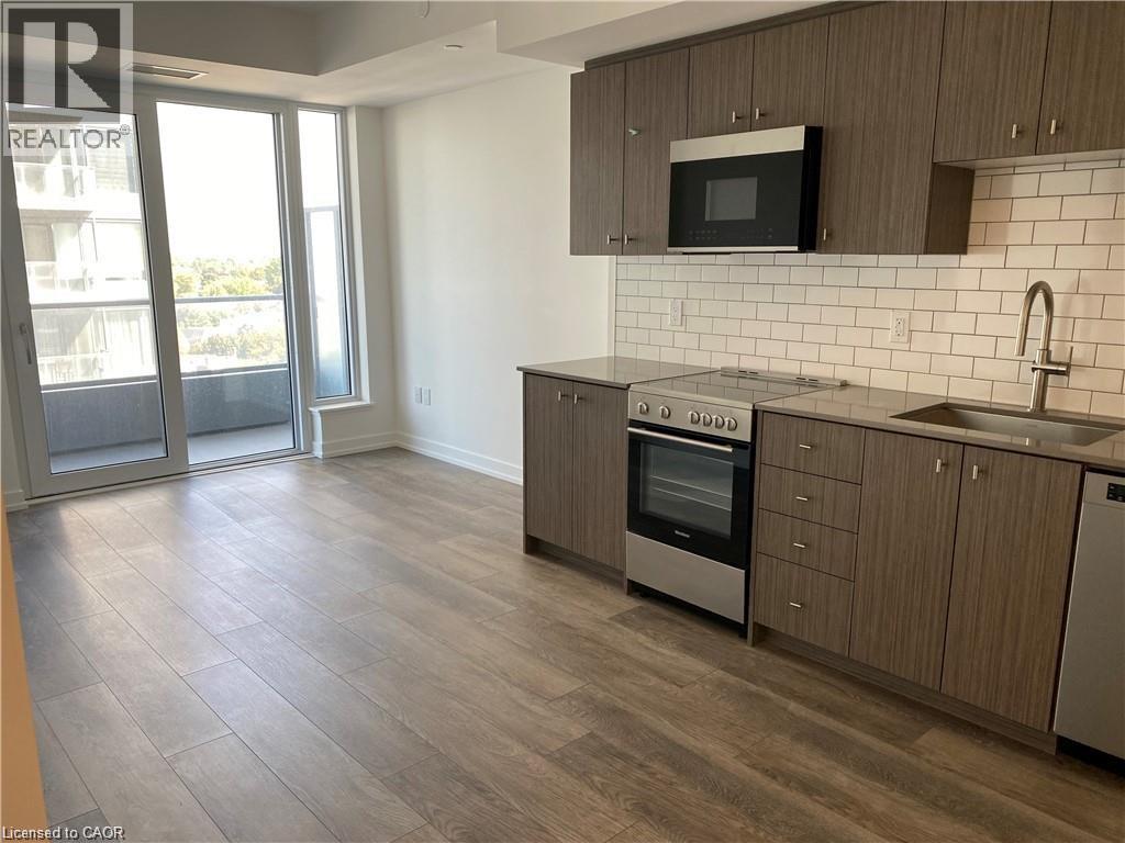 A kitchen with a stove top oven and microwave.