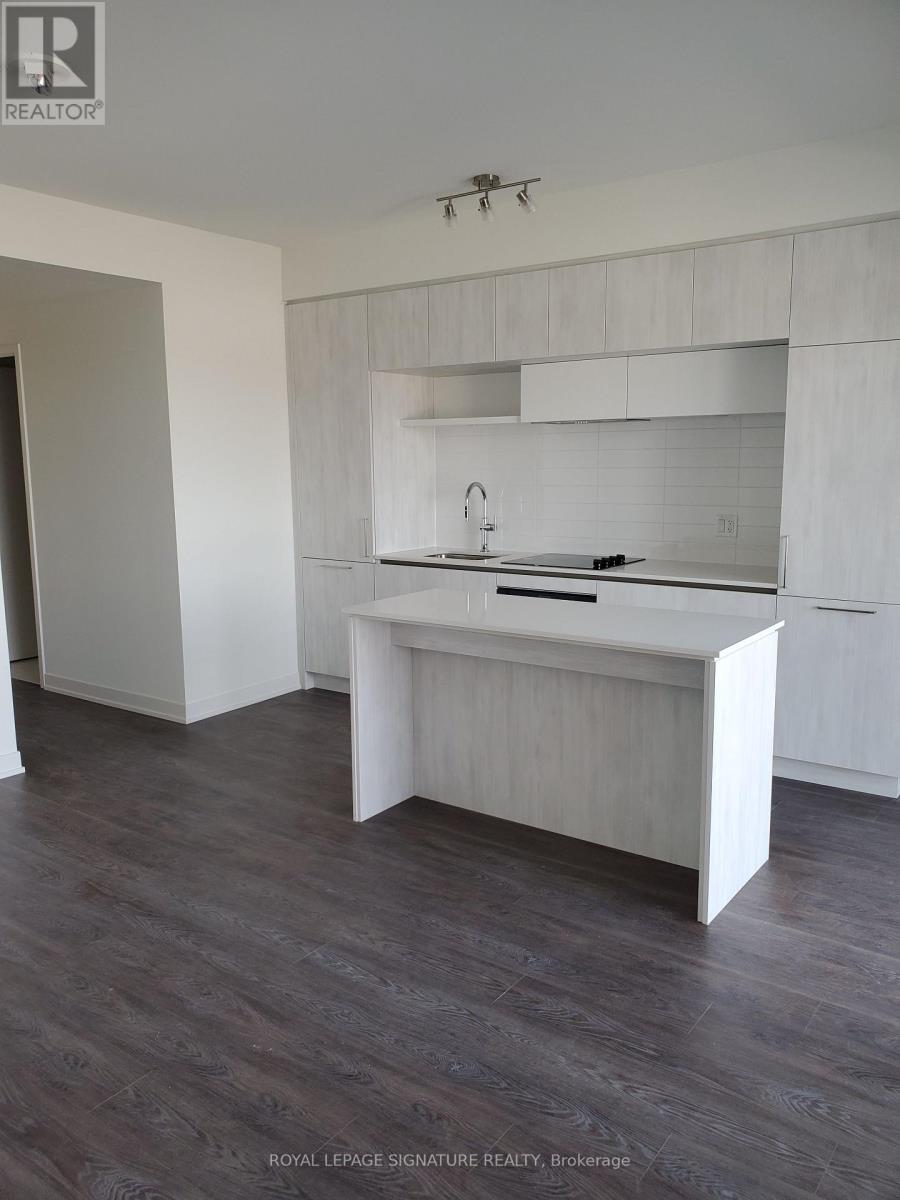 A white kitchen with a sink and a counter.