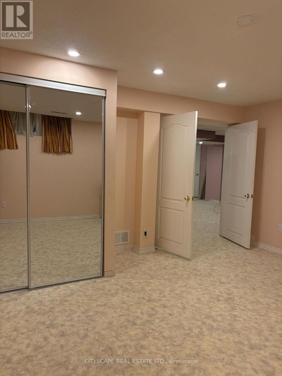 A bedroom with a sliding door and carpeted floor.
