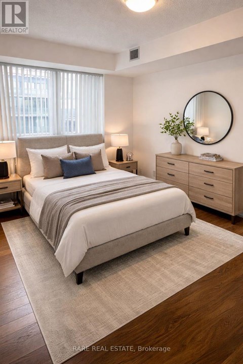 A bedroom with a bed, nightstands, and a round mirror on the wall.