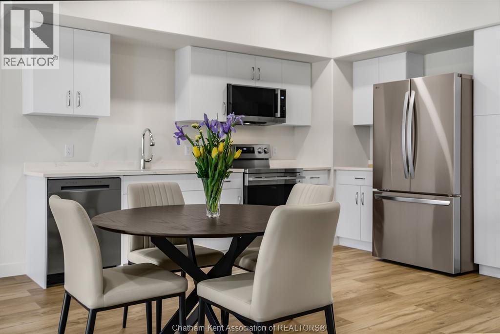 A modern kitchen with a table and chairs.
