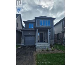 A house with a grey front yard and a garage door.