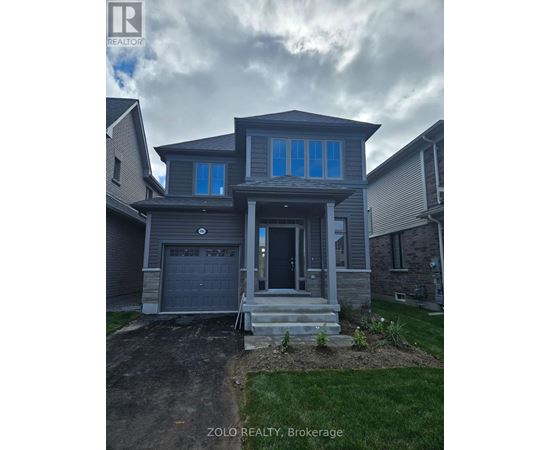 A house with a grey front yard and a garage door.