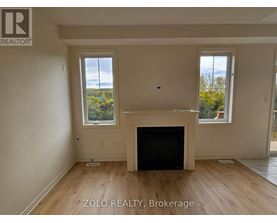 A living room with a fireplace and two windows.