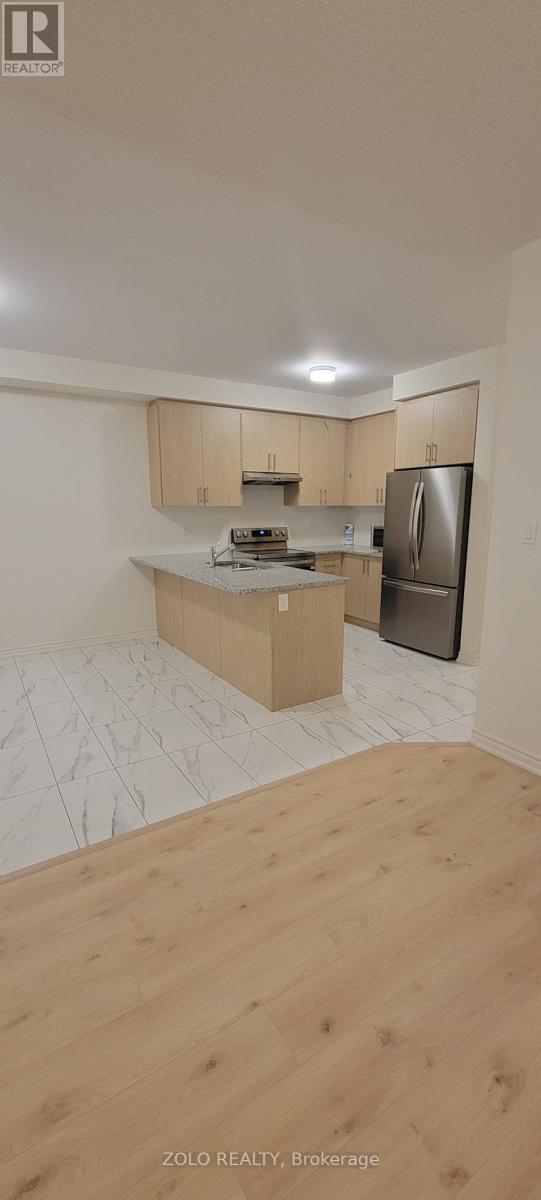 A kitchen with wooden cabinets and a refrigerator.