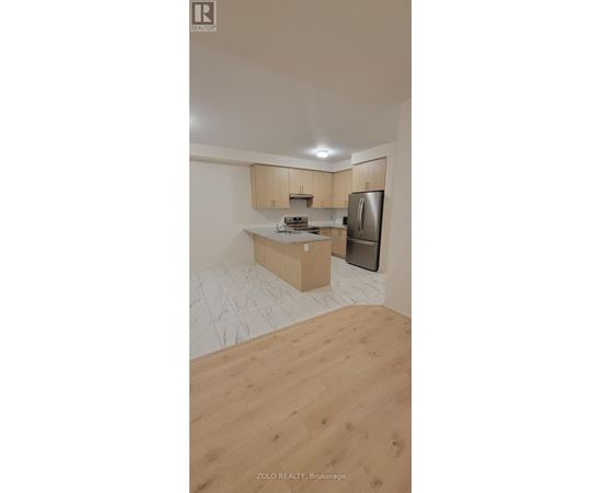 A kitchen with wooden cabinets and a refrigerator.