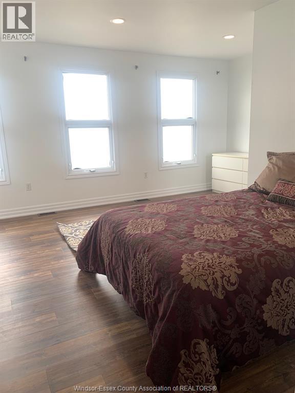 A bedroom with a bed and a dresser.