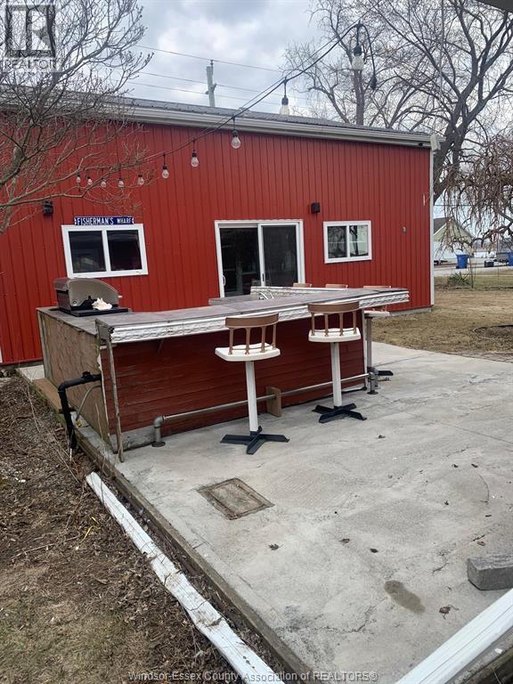 A red building with a white table in front of it.