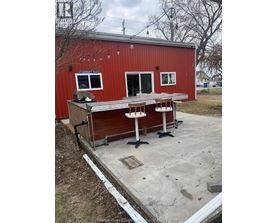A red building with a white table in front of it.