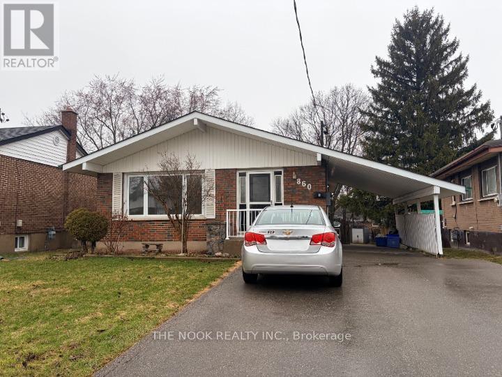 A house with a car parked in front of it.