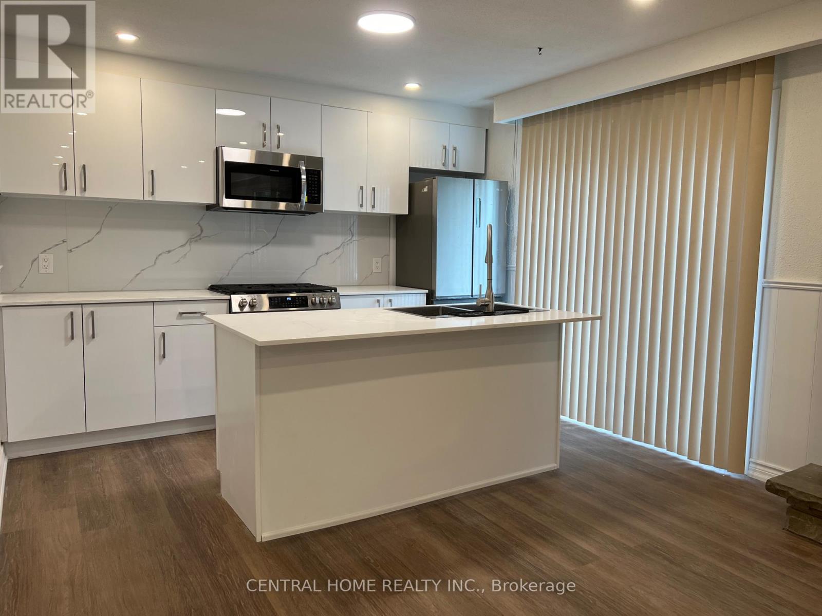 A kitchen with white cabinets and a countertop.