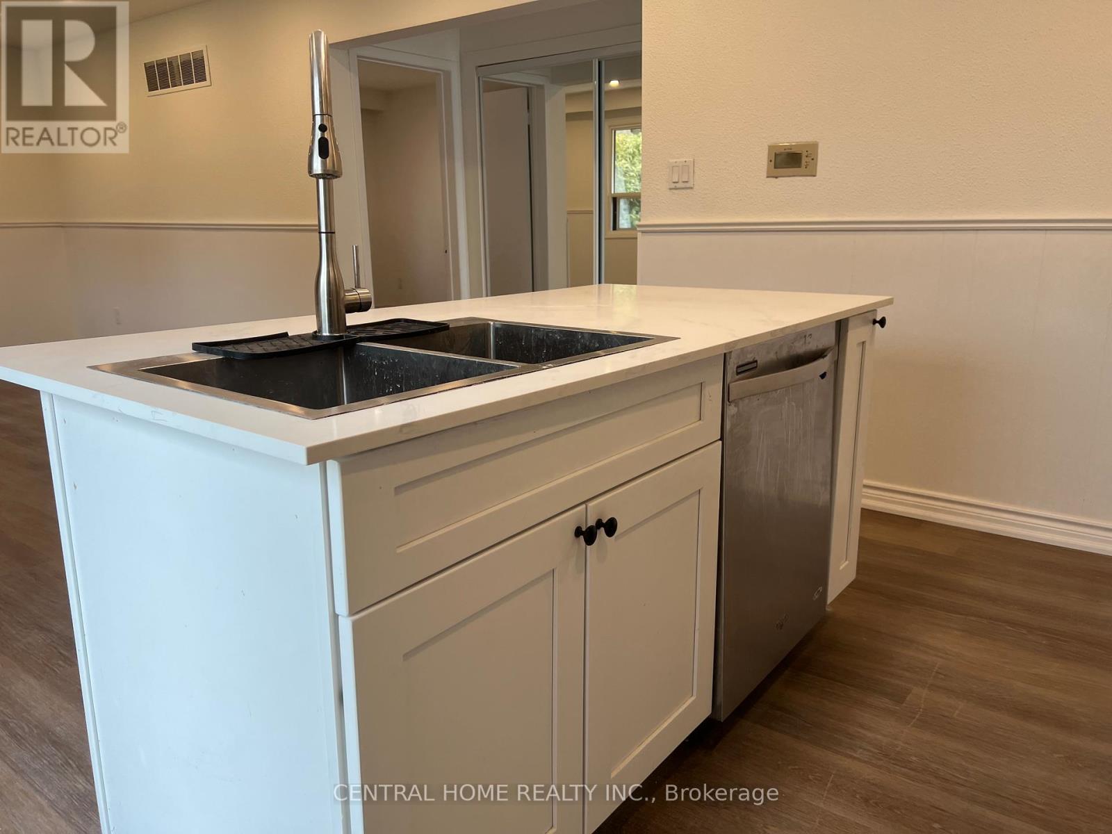 A kitchen with a sink and cabinets.