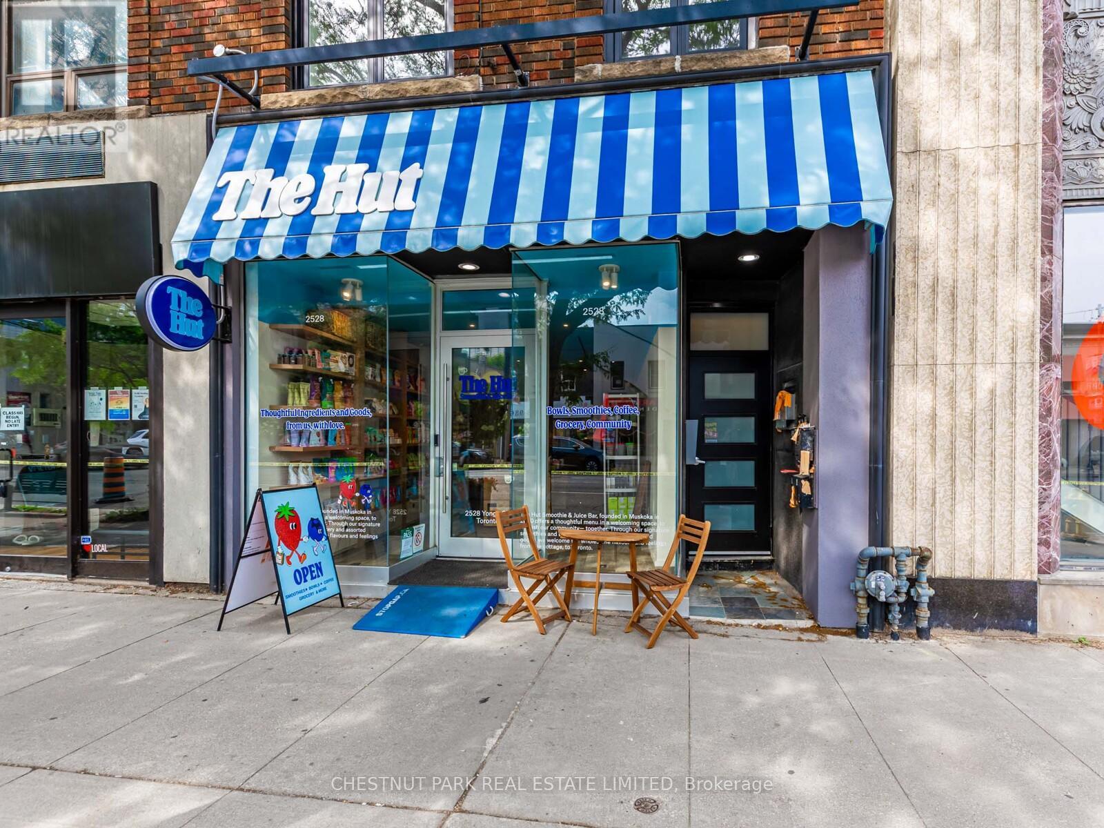 A storefront with a blue and white striped awning.