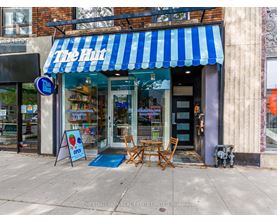A storefront with a blue and white striped awning.