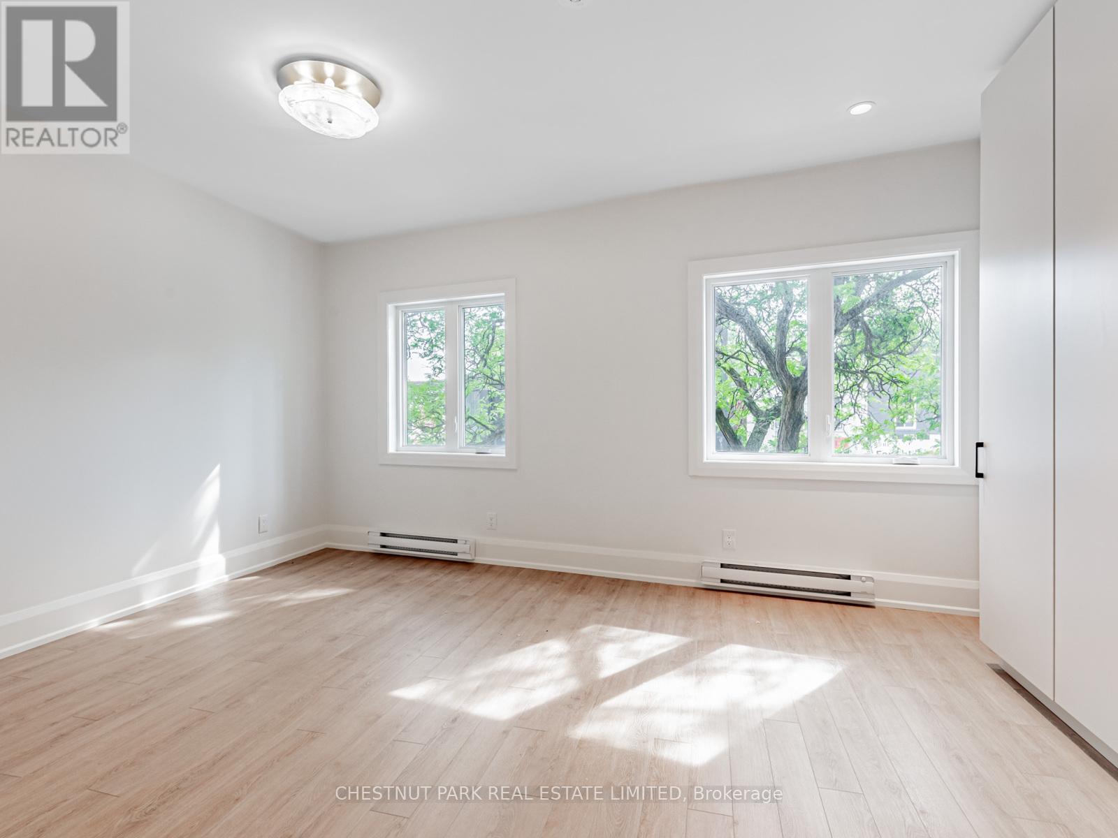 A well lit room with a window and a door.