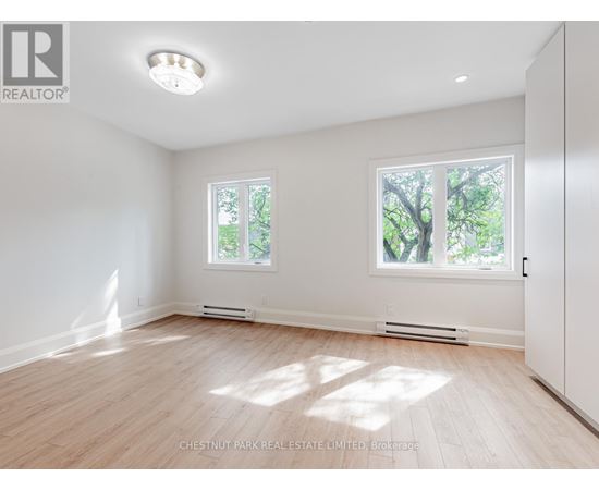A well lit room with a window and a door.