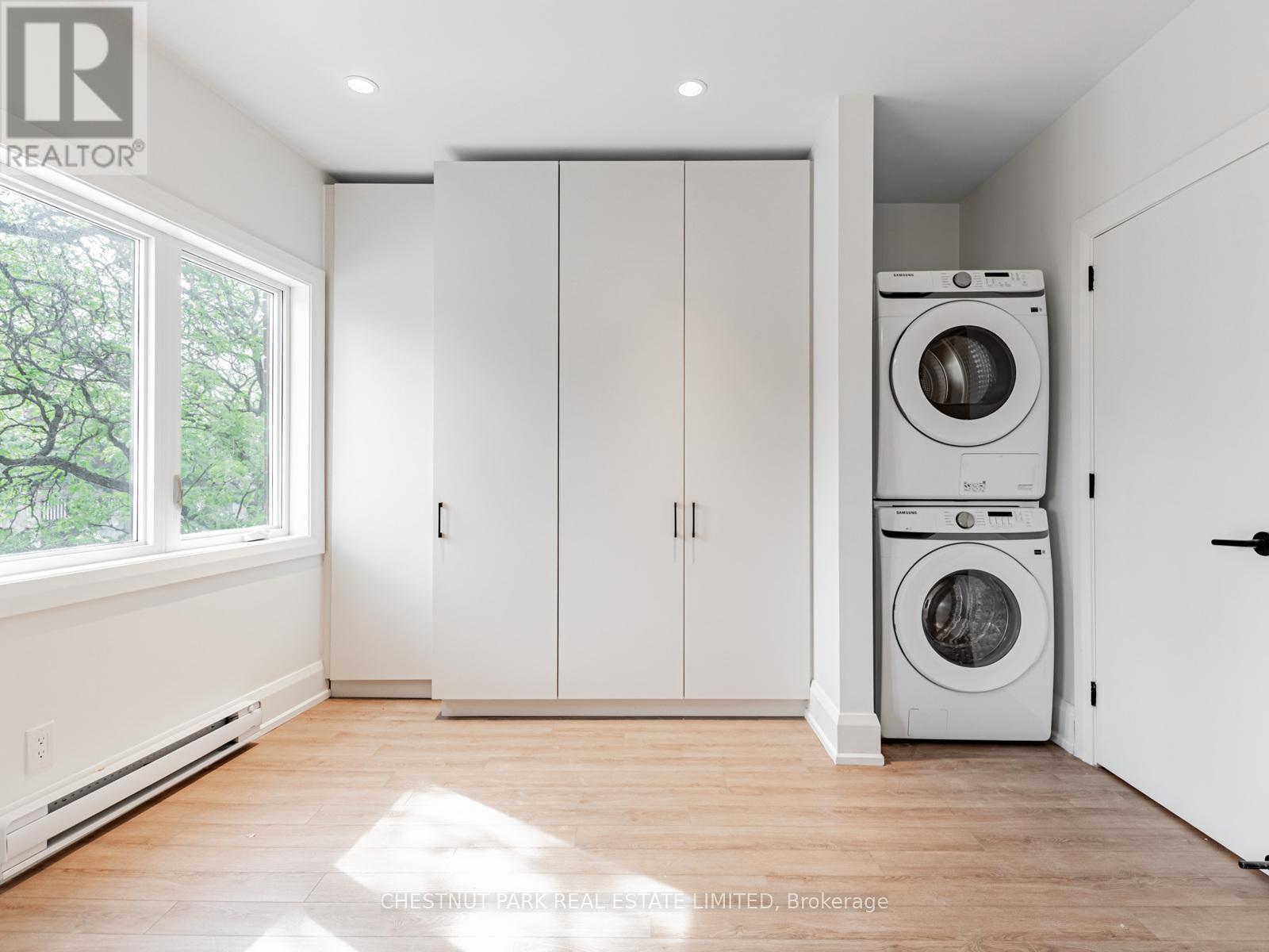 A laundry room with a washer and dryer stacked on top of each other.