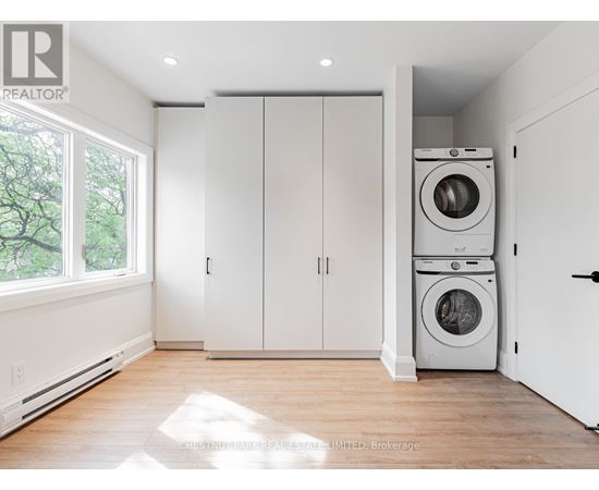 A laundry room with a washer and dryer stacked on top of each other.
