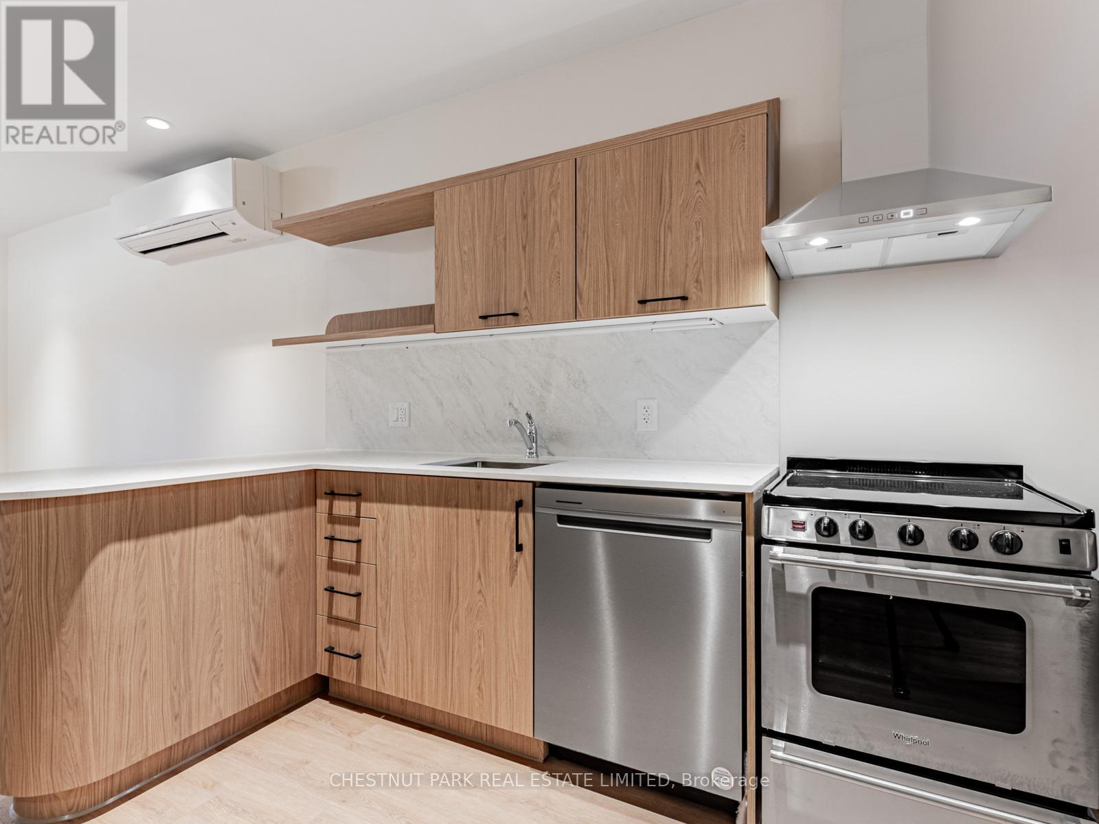 A kitchen with wooden cabinets and stainless steel appliances.