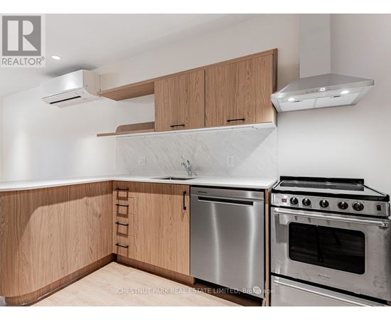A kitchen with wooden cabinets and stainless steel appliances.