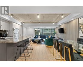 A modern kitchen with a bar area and a living room area.