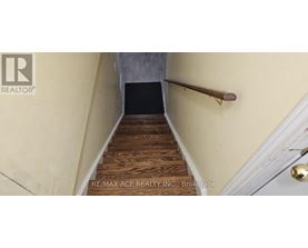 A staircase with wooden steps and a metal handrail.