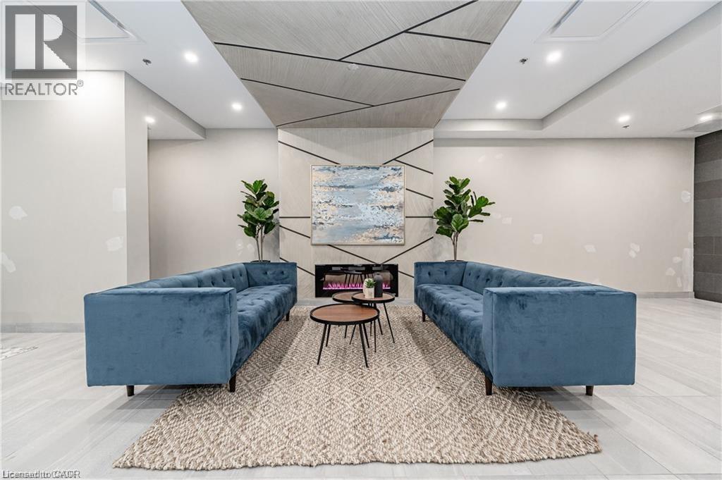 A living room with a blue couch and a rug.