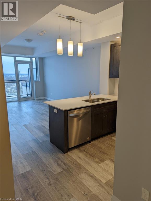 A modern kitchen with a large island and stainless steel appliances.