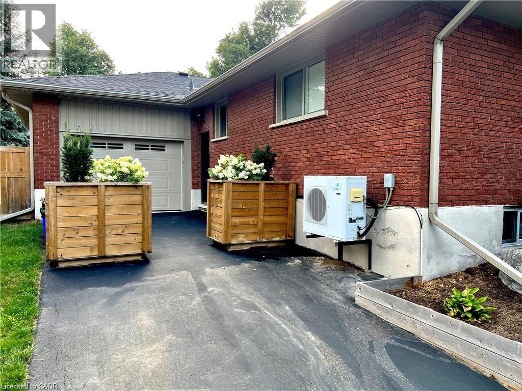 A red brick house with a driveway and a garage door.