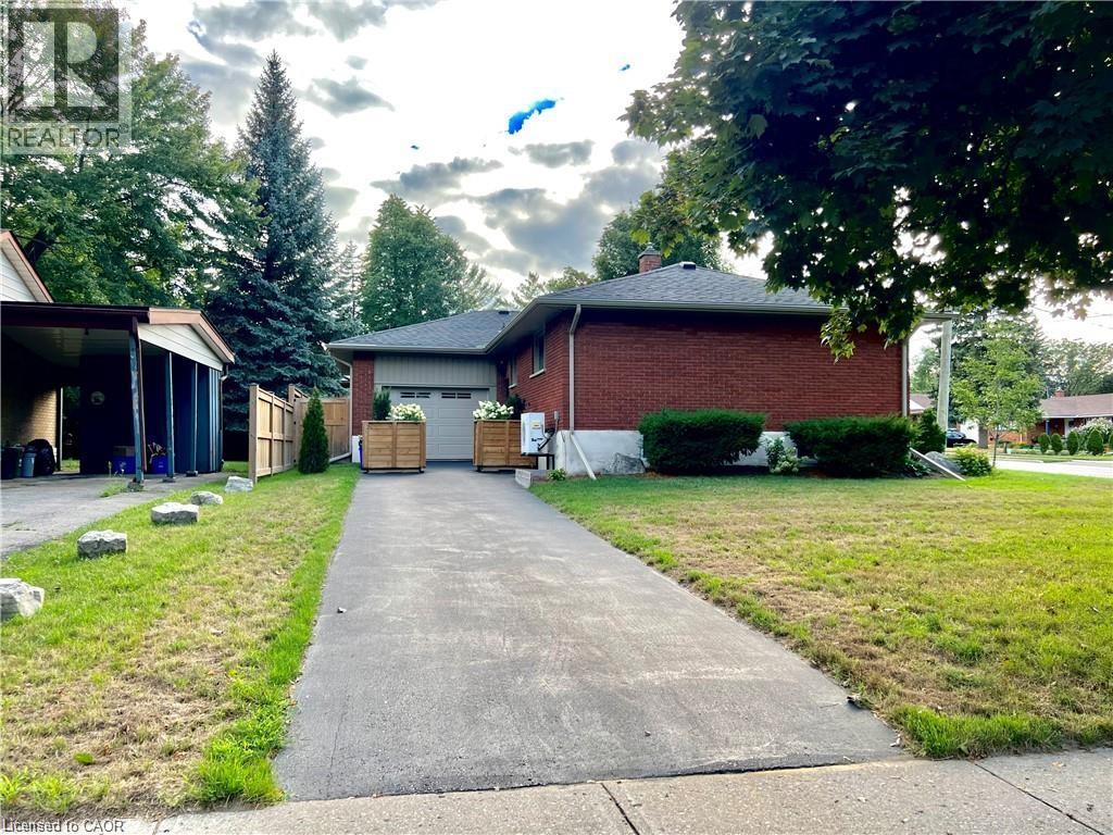 A driveway leads to a house with a garage.