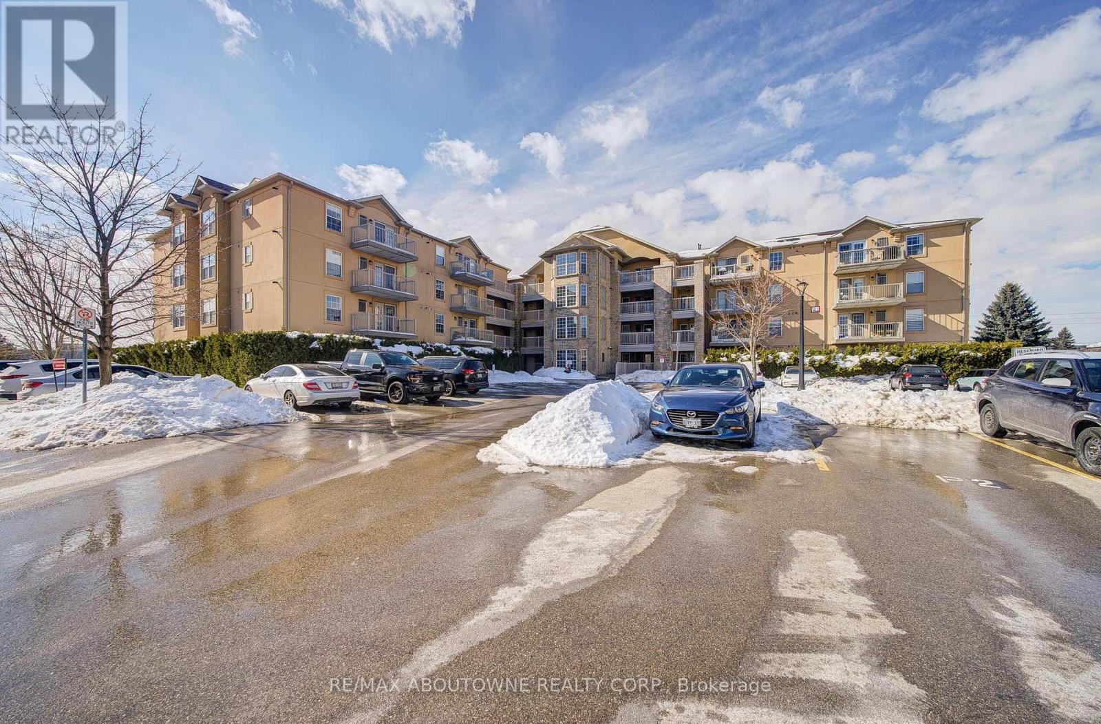 A parking lot with cars and apartment buildings in the background.