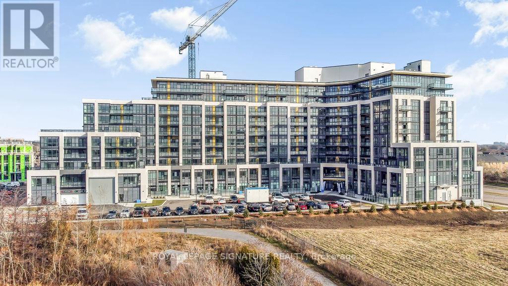 A large, modern building under construction with a crane in the background.