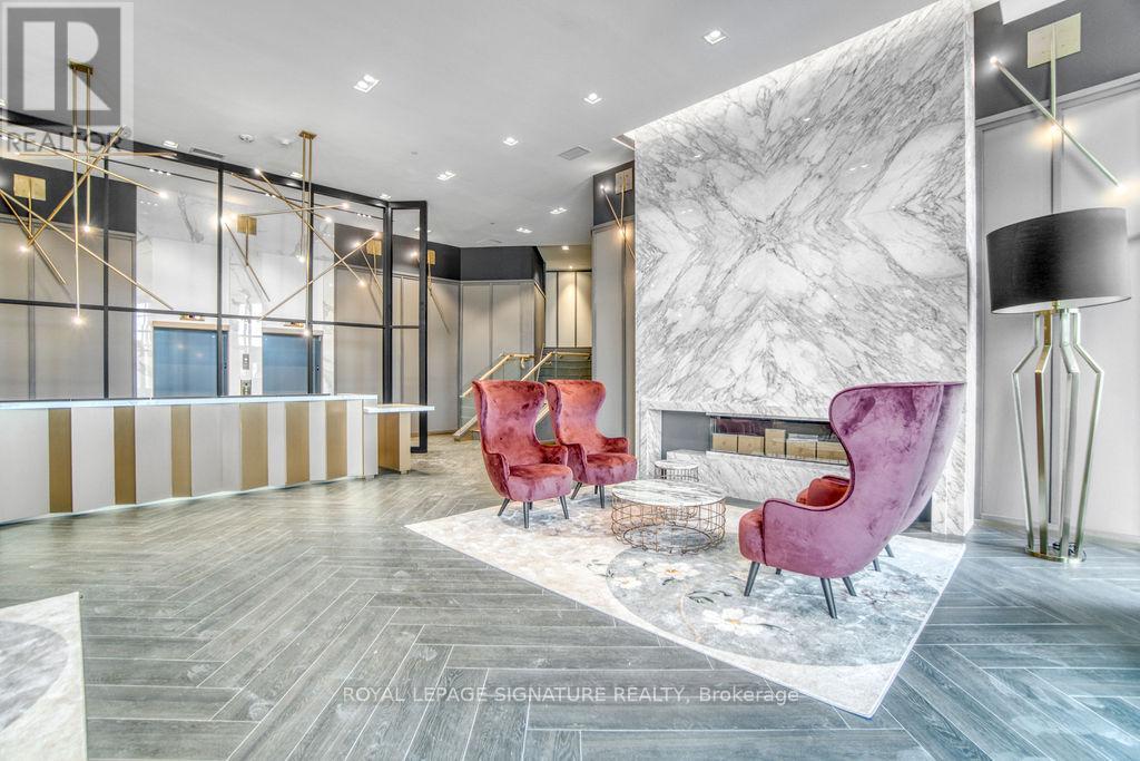 A modern living room with a marble wall and a fireplace.