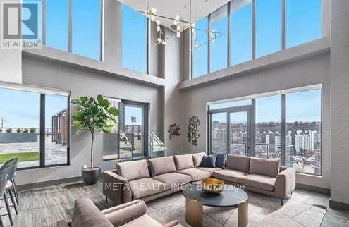 A modern living room with a large window overlooking a cityscape.