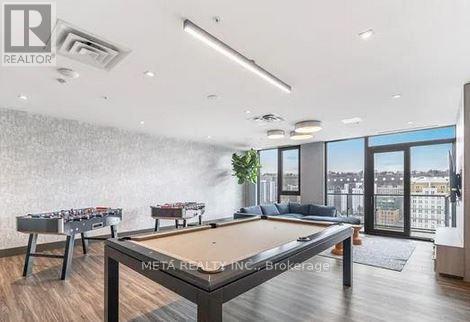 A pool table in a room with a view of the city.